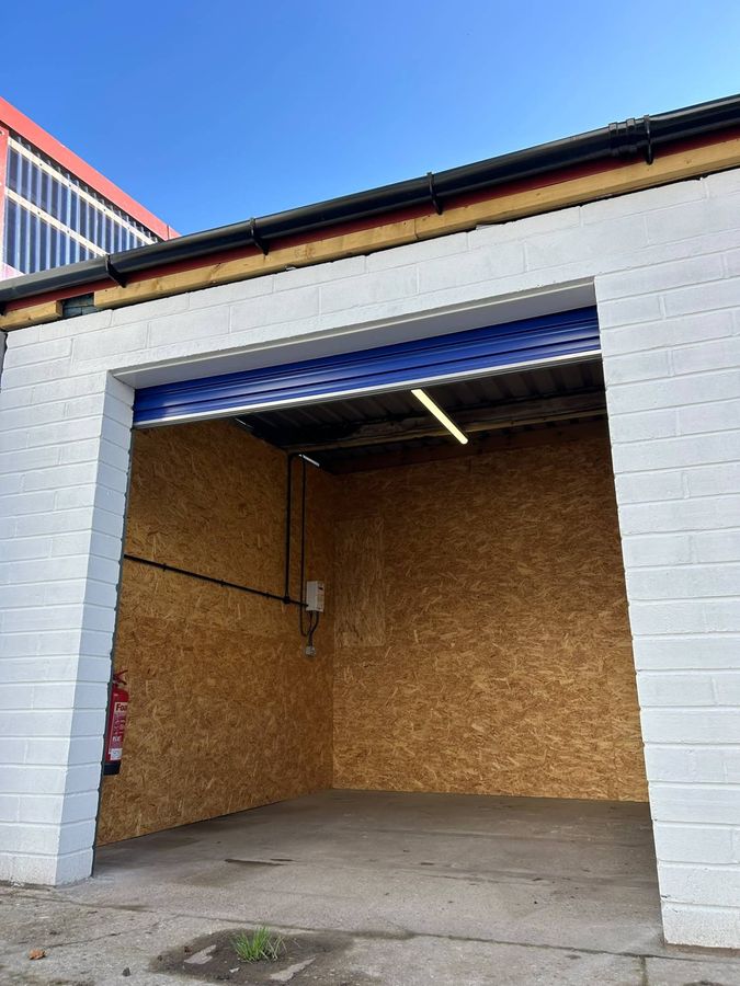 Lined storage unit with roller shutter door, lighting and sockets