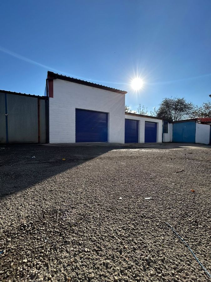 The yard and units with blue roller shutter doors